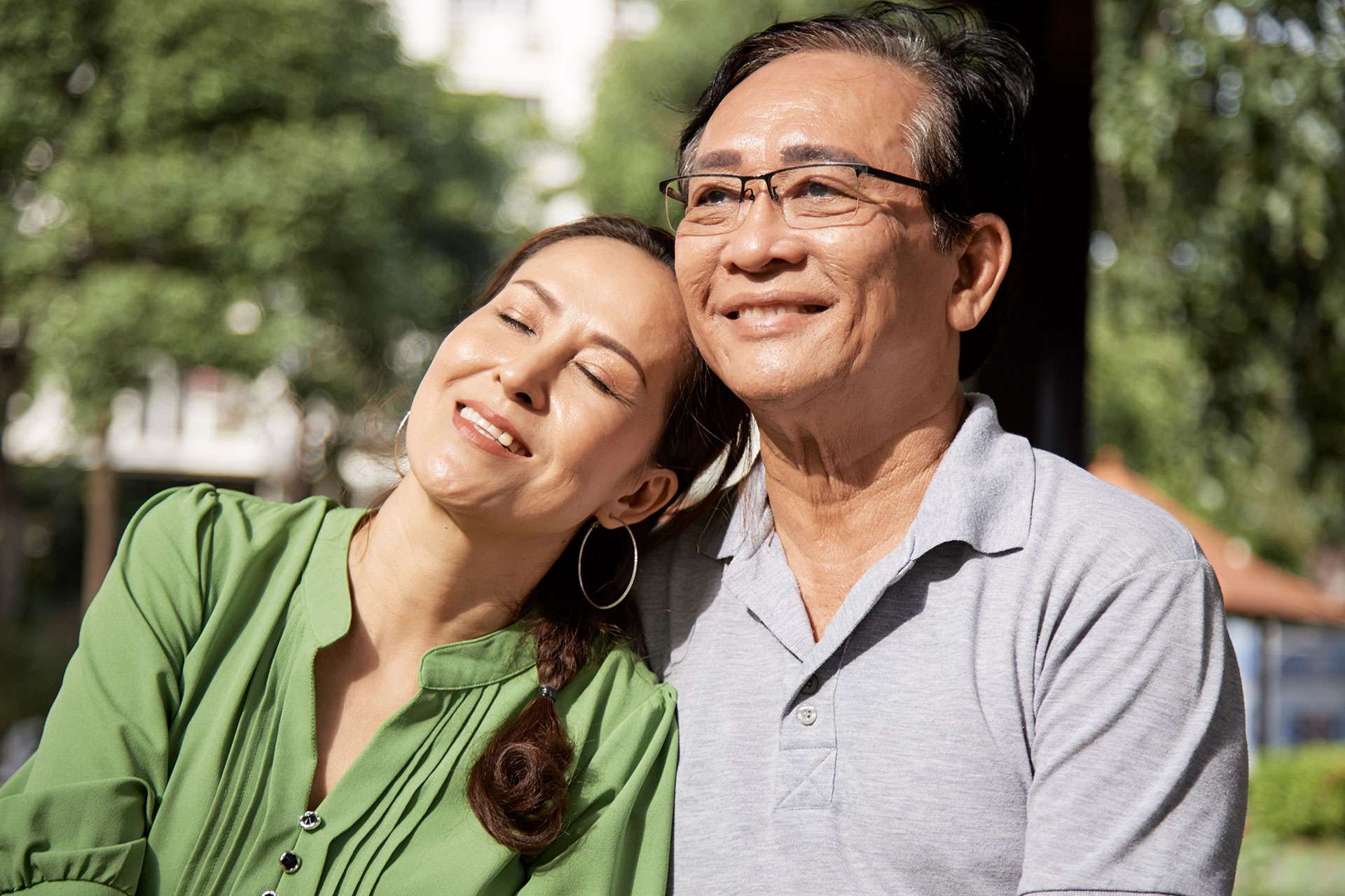 Smiling couple enjoying sunny day outdoors.