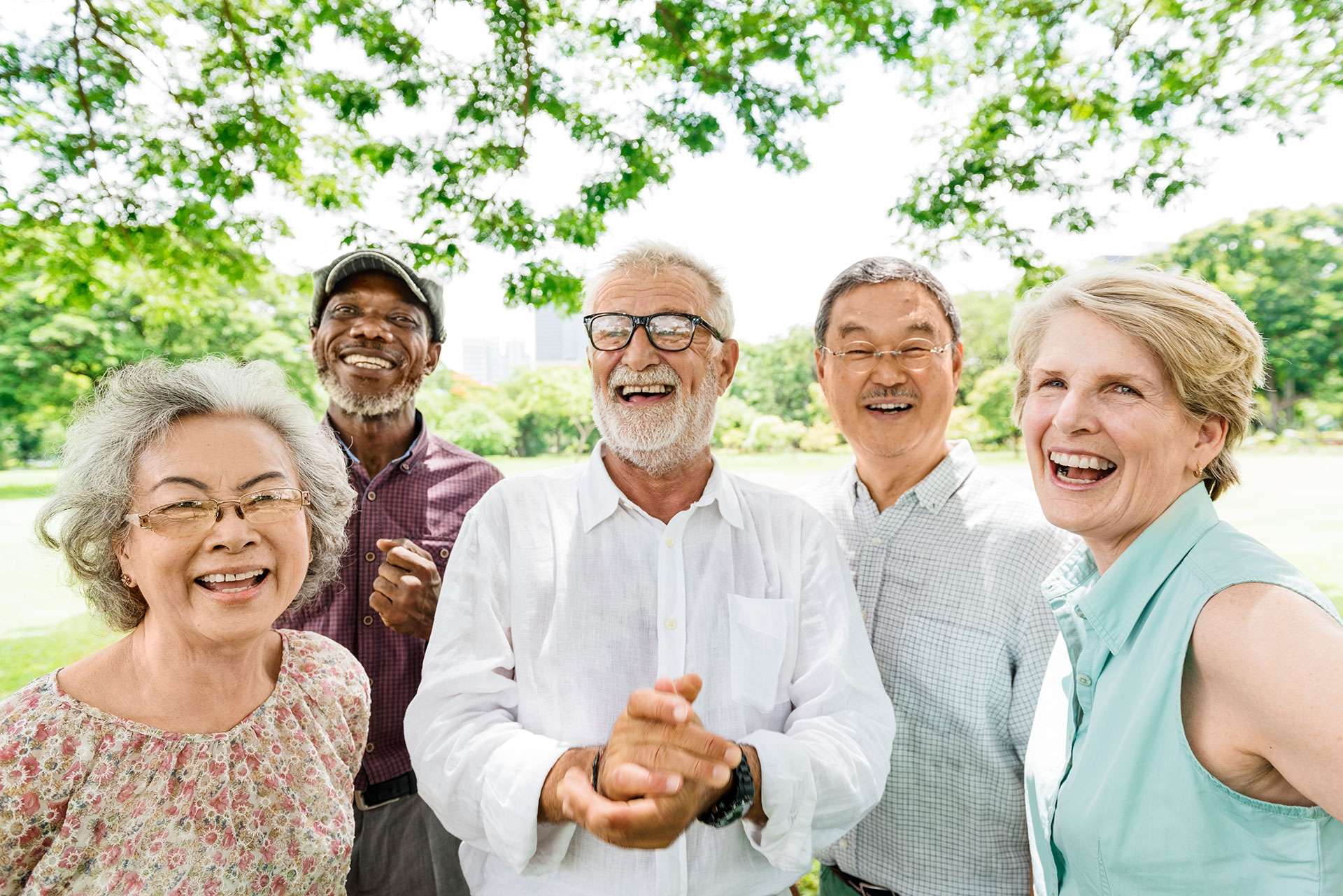 Happy group of diverse seniors enjoying the outdoors together.